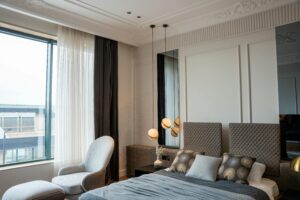 Luxurious bedroom featuring modern furniture and elegant decor, bathed in natural light.