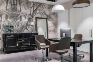 Stylish contemporary office space with elegant furniture and artistic wallpaper, perfect for a modern workspace.